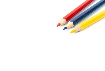 Primary color pencils placed on a white background in the home studio. The concept is used as a media illustration.