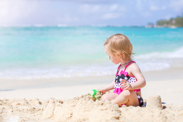 Adorable little girl have fun at tropical beach during vacation