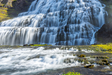 The big and powerful Dynjandi waterfall in the westfjords of Iceland during summer and sunny day. Holiday and travelling concept.