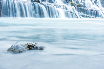 Hraunfossar volcanic streams and cascade early morning in the Reykholt area in Iceland. Holiday and nature photography concept.