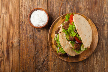 Kebab, kofta in pita, bun. Traditional southern European dish. Top view.