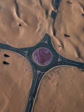 Empty road in desert covered by sand, Dubai, UAE