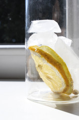 Water with ice and lemon in a glass