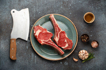 Raw marbled meat steaks with cleaver
