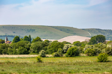 Looking over fields in the South Downs towards the village of Rodmell