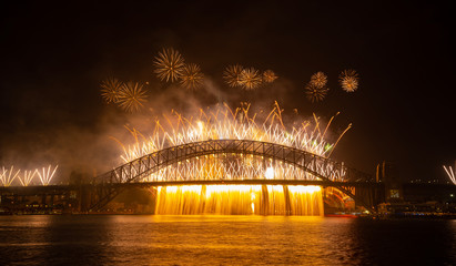 NYE fireworks on Sydney Harbour Bridge. Western view from Blues Point Reserve.
