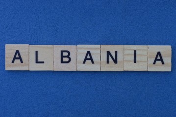 name of the country of albania from the word from gray wooden letters on a blue table
