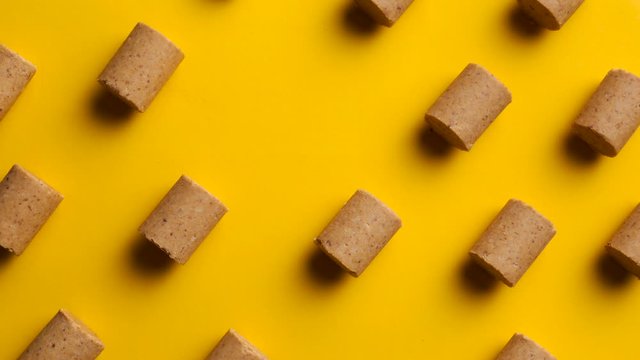 Brazilian typical peanut sweet "Pacoca" june party "festa junina" yellow background stop motion 4K