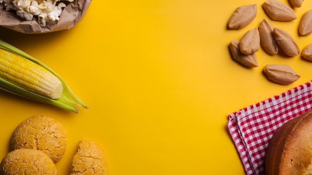 Brazilian typical foods june party "festa junina" yellow background frame stop motion 4k 