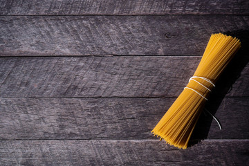 Spaghetti laying on the table waiting to be cooked
