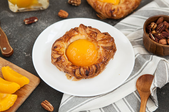 tartlet with apricot, sweet pastries on a black background, pastry shop.