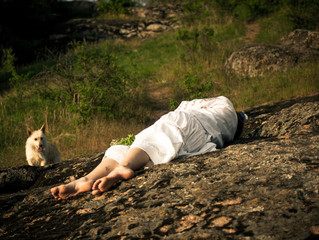 girl lying on stones unconscious