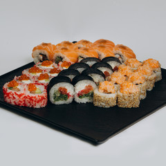 Sushi Set and sushi rolls served on stone slate