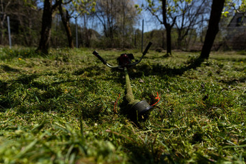 Naklejka premium Lawn mower in the grass after finishing mowing