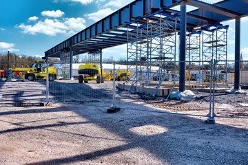 Construction site of a bridge, construction machinery and excavators under a blue sky