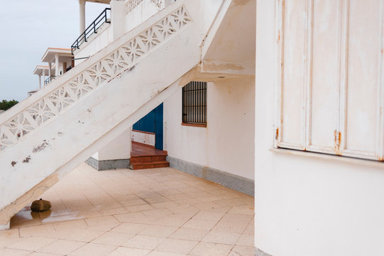 Stairs in white residential building on rainy day 