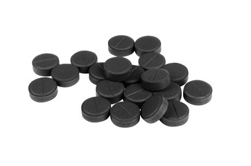 Black activated carbon tablets isolated on white background
