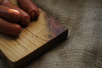 Fried sausages on a wooden board