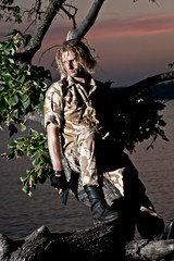 a soldier with a weapon in his hands by the river