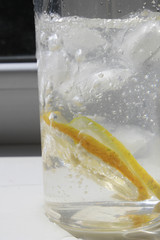 Ice with ice and lemon in a glass