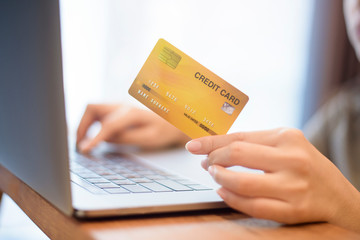 Woman hand is holding credit card, shopping online