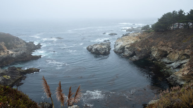 pacific oecan under the mist with waves and rocks