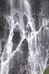 Close-up view of the fresh, noisy and intense water in Tumpak Sewu Waterfall, in East Java, Indonesia.