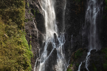 Fototapeta na wymiar Close-up view of the fresh, noisy and intense water in Tumpak Sewu Waterfall, in East Java, Indonesia.