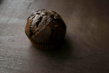 Chocolate cupcakes on a white plate on a brown background