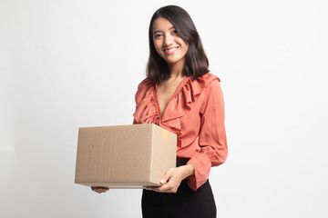Delivery, relocation and unpacking.  young asian woman holding cardboard box .