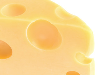 close up of piece of cheese with holes