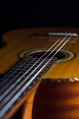 Obraz na płótnie Canvas classic spanish guitar on black background