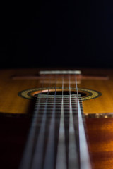 classic spanish guitar on black background