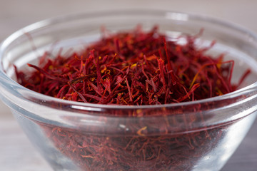 Fototapeta premium Close up on spice glass with red saffron on cutting board