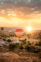 Sunset with hot air ballons Goreme, Cappadocia, Turkey  - obrazy, fototapety, plakaty