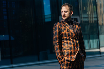 Caucasian young businessman in full height stands with a folder in his hands . space for writing