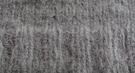 Graue Angorawolle von einem Pullover als Textur und Hintergrund