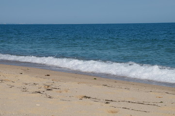 empty beach in the summer - sea, sand, white waves
