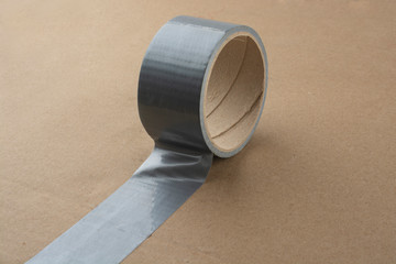 A roll of silver adhesive tape for packaging.
