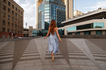 girl runs away in the city.  blurred background. 