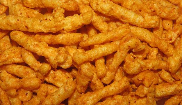 Healthy crunchy snack, Kurkure snack, Evening Snack or the Tea Snack, Kurkure is an evening snack that is manufactured using edible ingredients like rice meal, Background Texture.