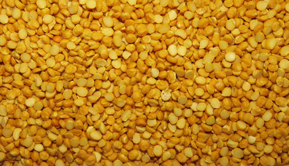 Close up of Isolated Split peas, Split peas are an agricultural or culinary preparation consisting of the dried, peeled and split seeds of Pisum sativum, the pea. Background Texture.
