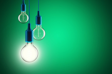 Idea and leadership concept - bulbs on the green background