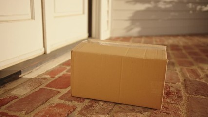 Contactless delivery of a parcel, courier delivering package to the doorstep - Powered by Adobe