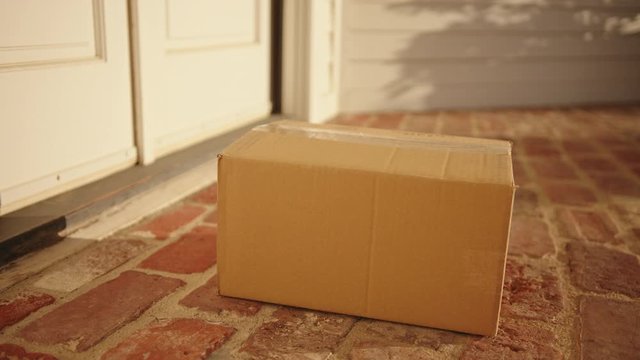 Contactless delivery of a parcel, courier delivering package to the doorstep