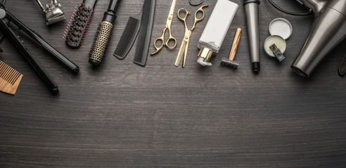 Classic grooming and hairdressing tools on wooden background.