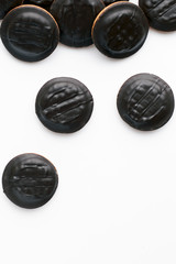 Top view of round chocolate homemade cookies on a white background with a large space. Concept of making desserts and baking
