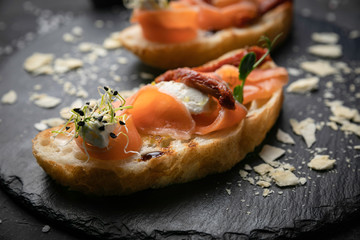 sandwich with salmon on a dark background