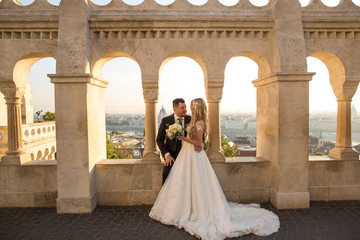 bride and groom posing in castle