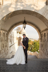 bride and groom posing in castle